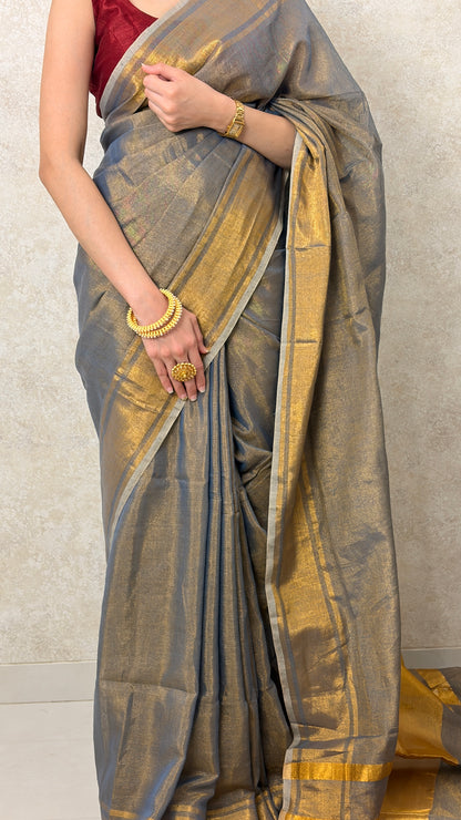 Graceful pose in Khadi Tissue Saree with golden highlights, perfect for festive wear