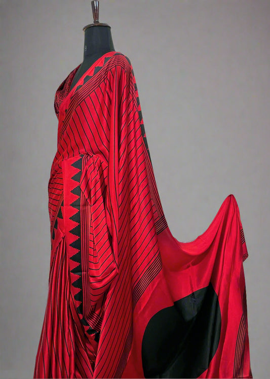 Mannequin wearing red Modal silk saree with black line print—styled for contemporary elegance, festive gatherings, and statement dressing.