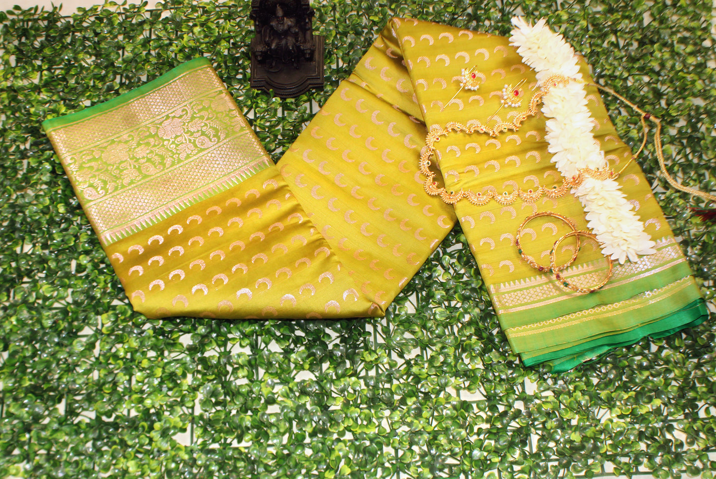 Moss green Chandrakor Butta saree with crescent motifs—blending subtle charm with lunar-inspired grace.