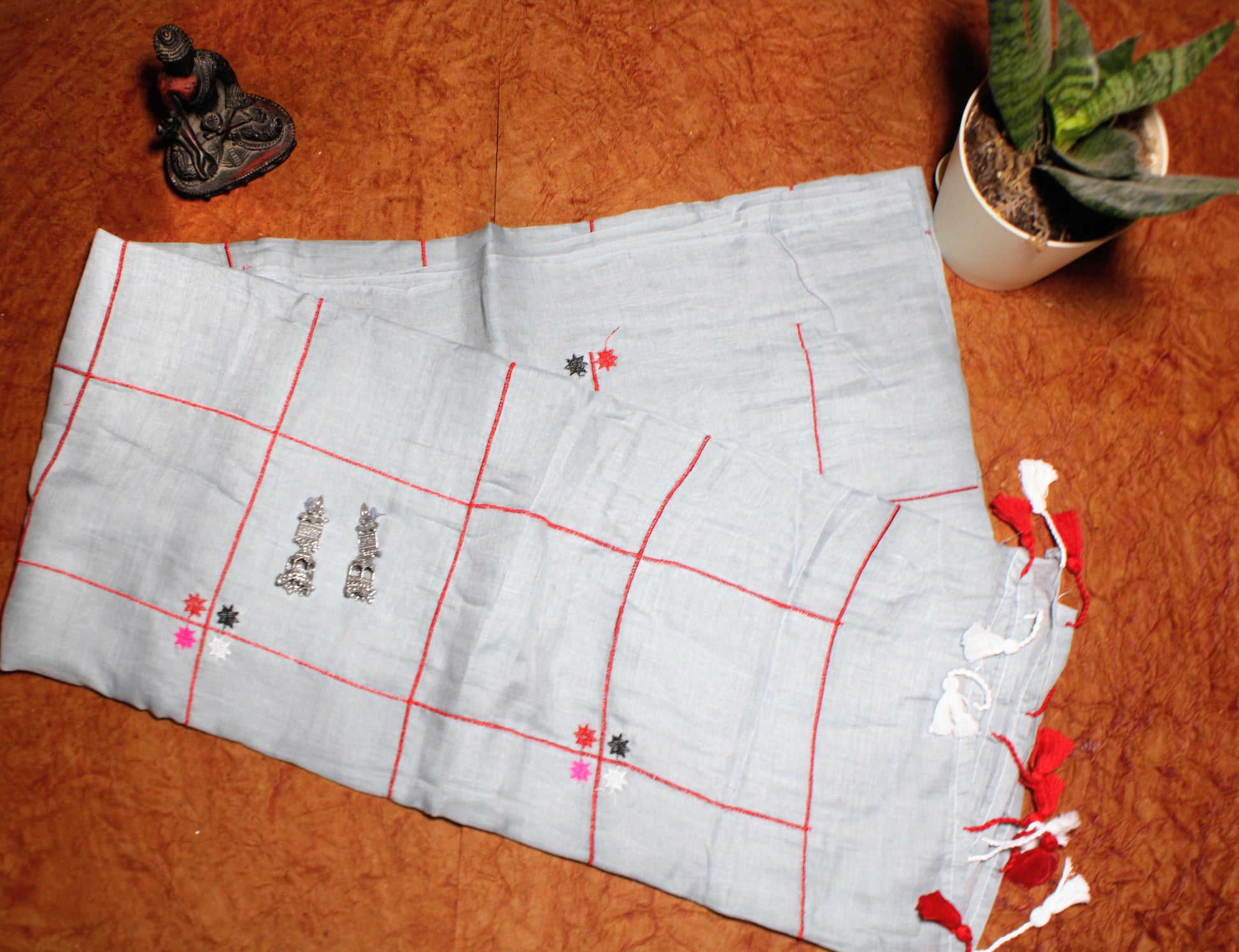 Close-up of pastel checks on grey cotton saree—highlighting tonal balance and refined detail