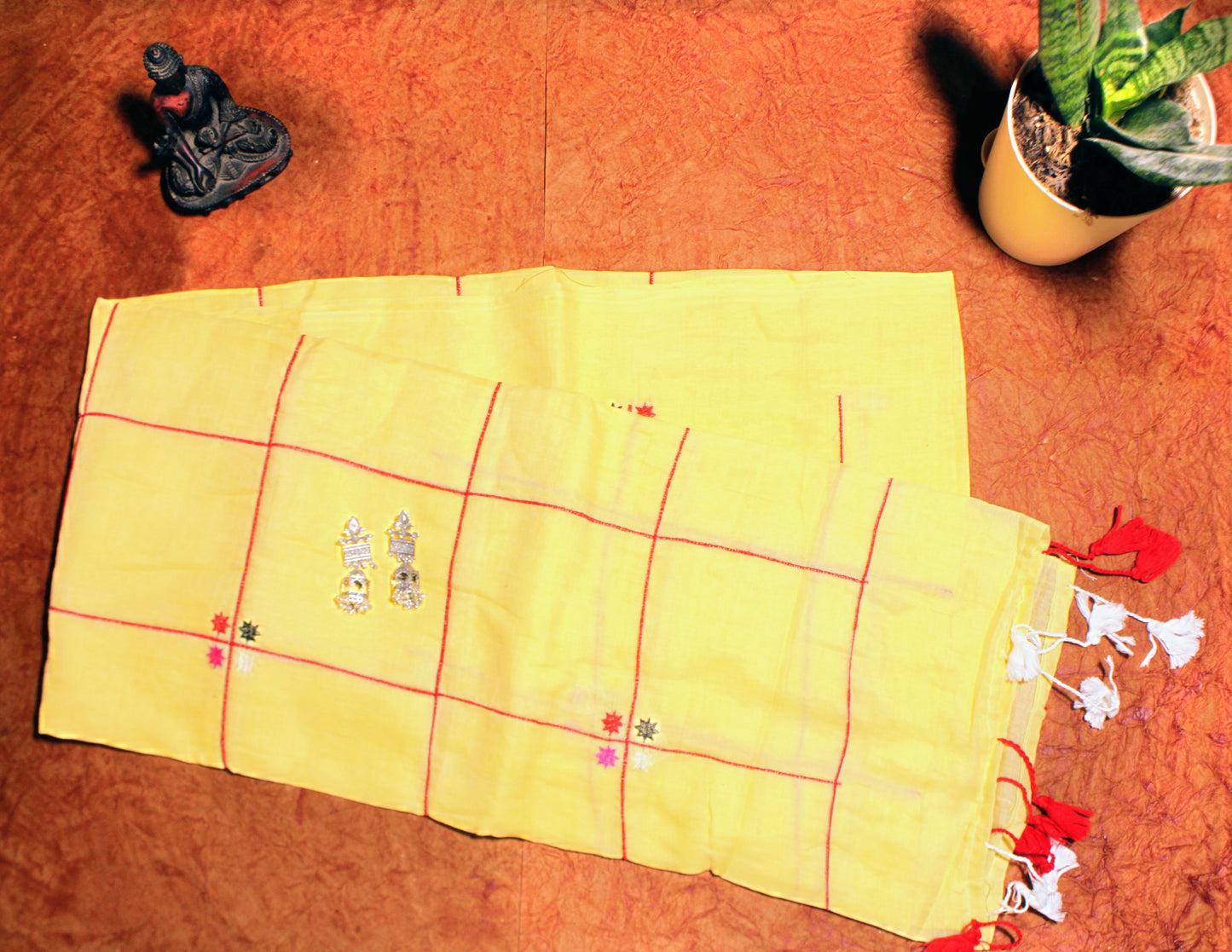 Close-up of pastel checks on yellow cotton saree—highlighting vibrant contrast and soft weave.