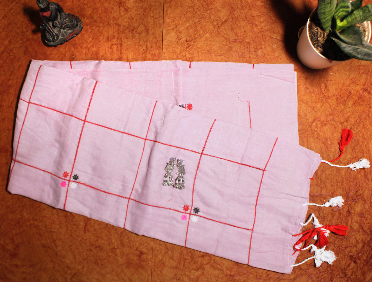 Close-up of pastel checks on pink cotton saree—highlighting gentle contrast and airy weave.