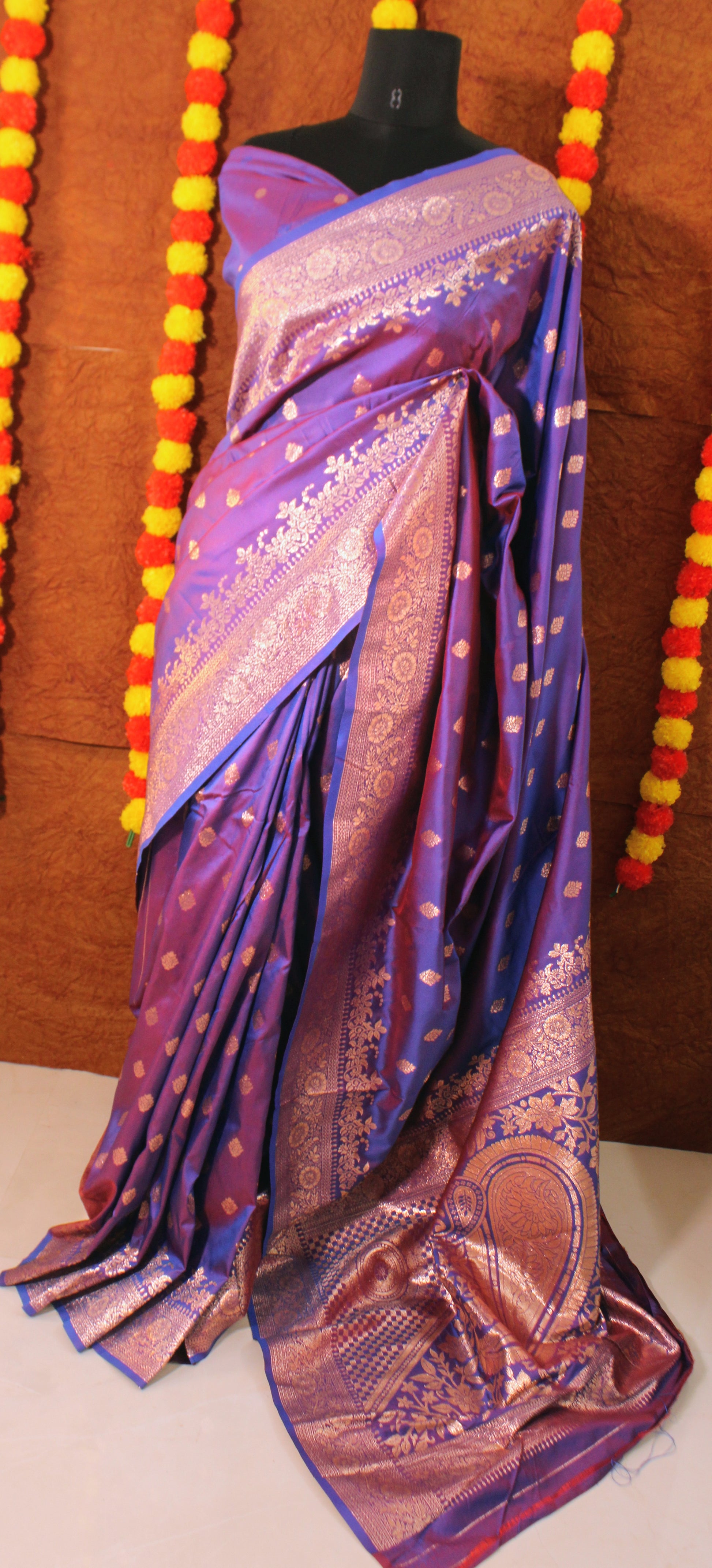 Banarasi Semi Silk saree displayed flat, showcasing intricate zari weaves and broad traditional borders—crafted for regal celebrations.