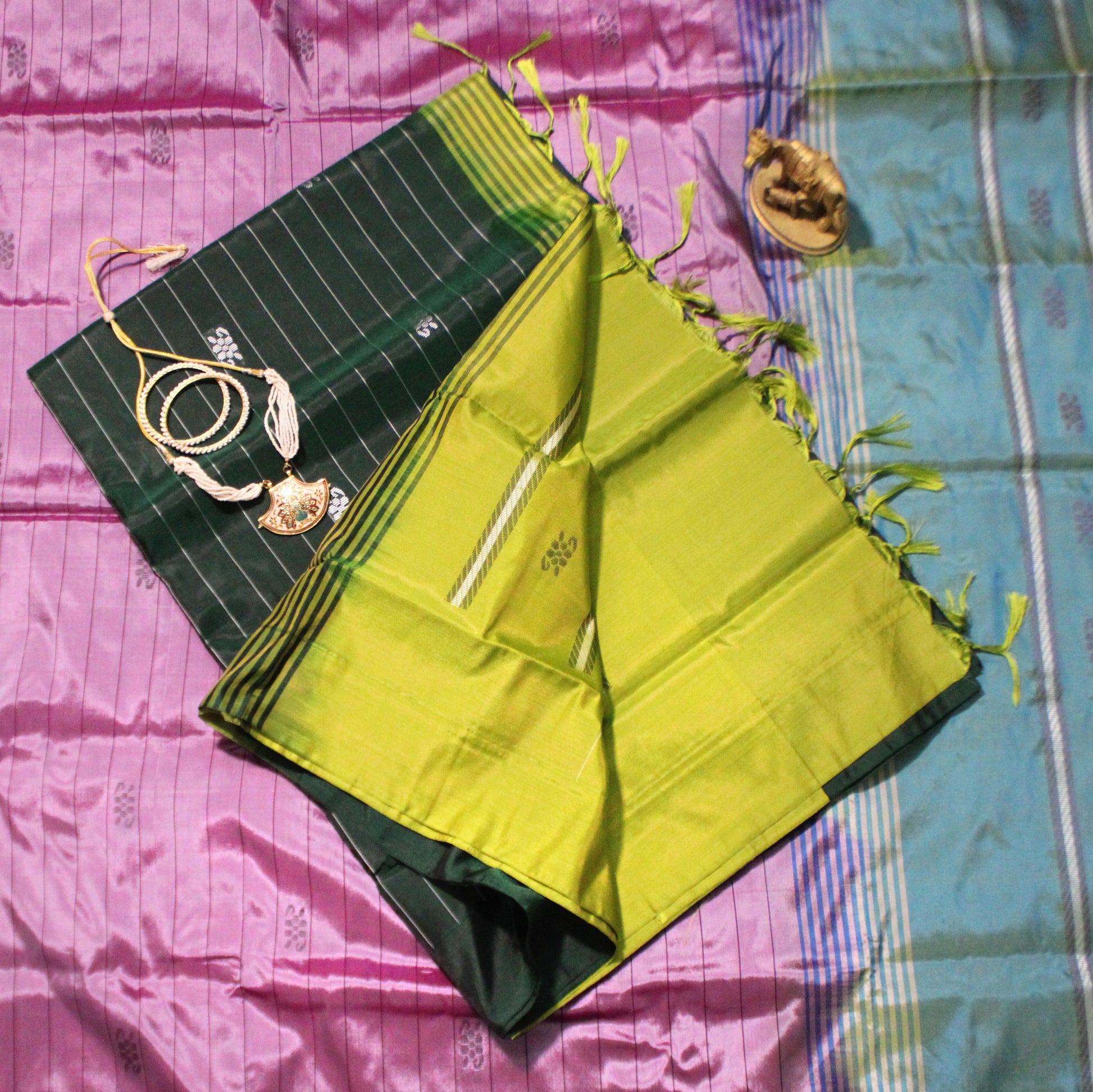 Dark green Banana Pith saree with subtle Resham lines and rich contrast accents—evoking earthy grace and timeless sophistication.