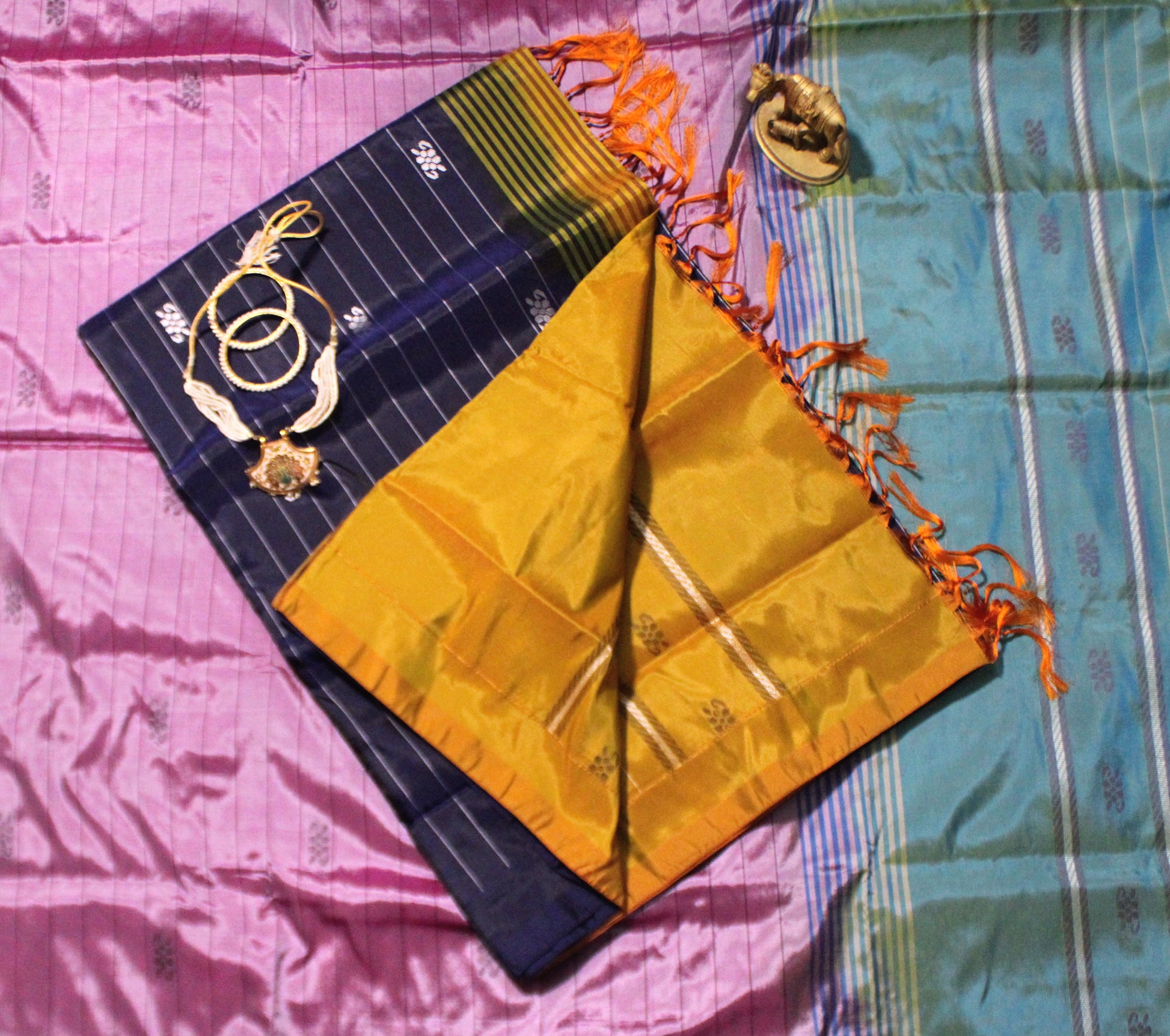 Navy Banana Pith saree with elegant Resham lines and bold contrast pallu—styled for modern poise and traditional depth.