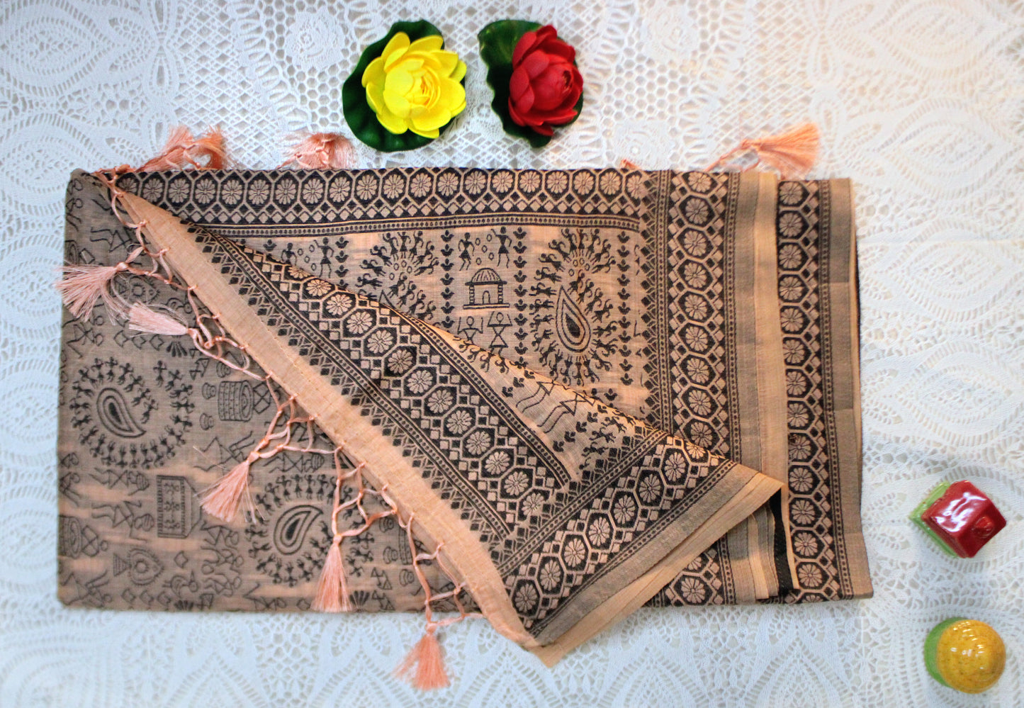 Peach cotton saree with Warli embroidery—blending pastel charm with folk-inspired detailing.