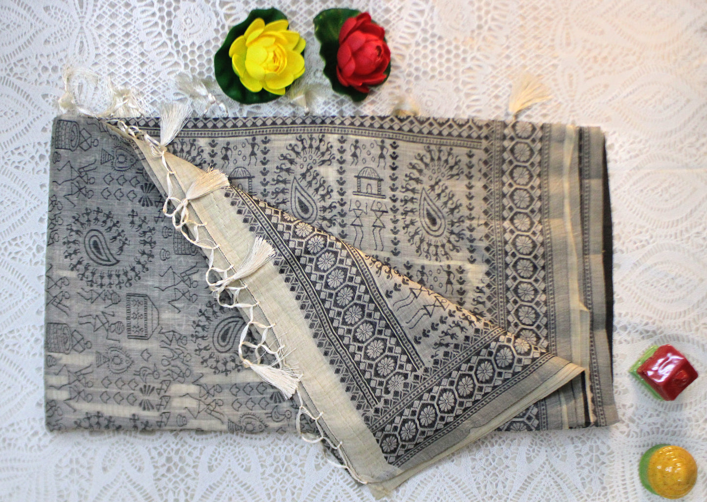 Beige cotton saree with Warli embroidery—styled for earthy elegance and subtle festive grace.