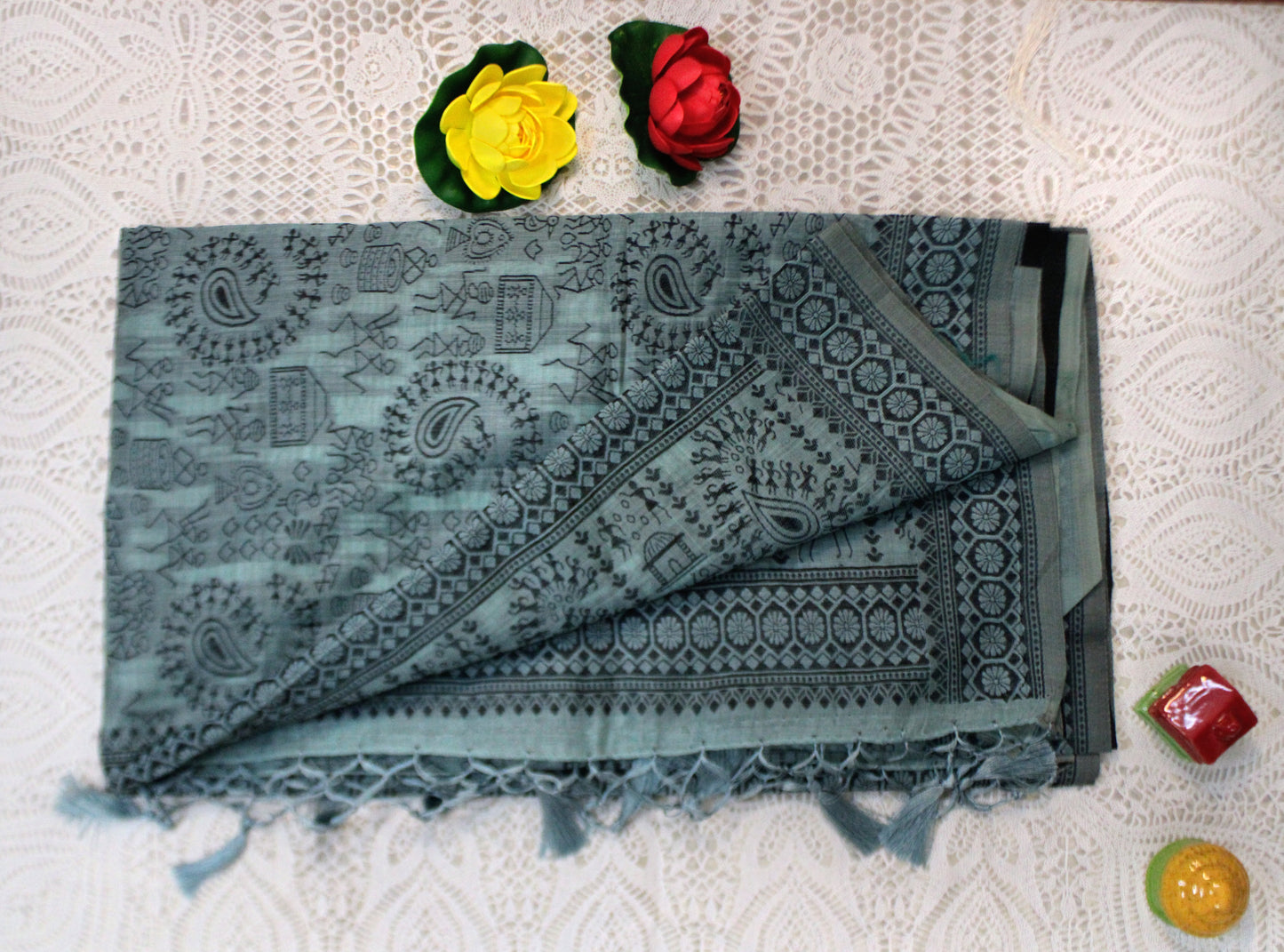 Peacock green cotton saree with Warli embroidery—styled for regal charm and folk-inspired finesse