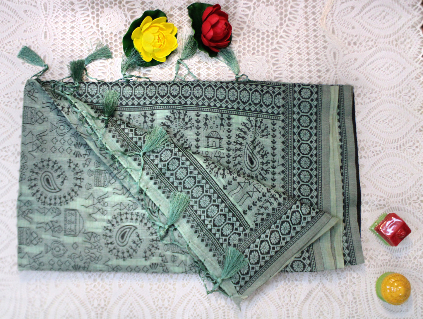 Teal green cotton saree with Warli embroidery—evoking artisanal depth and graceful movement.