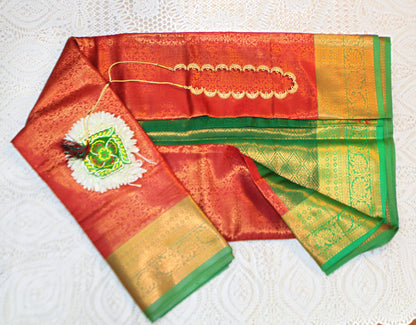 Close-up of golden zari on red semi silk saree—highlighting rich texture and ceremonial elegance.
