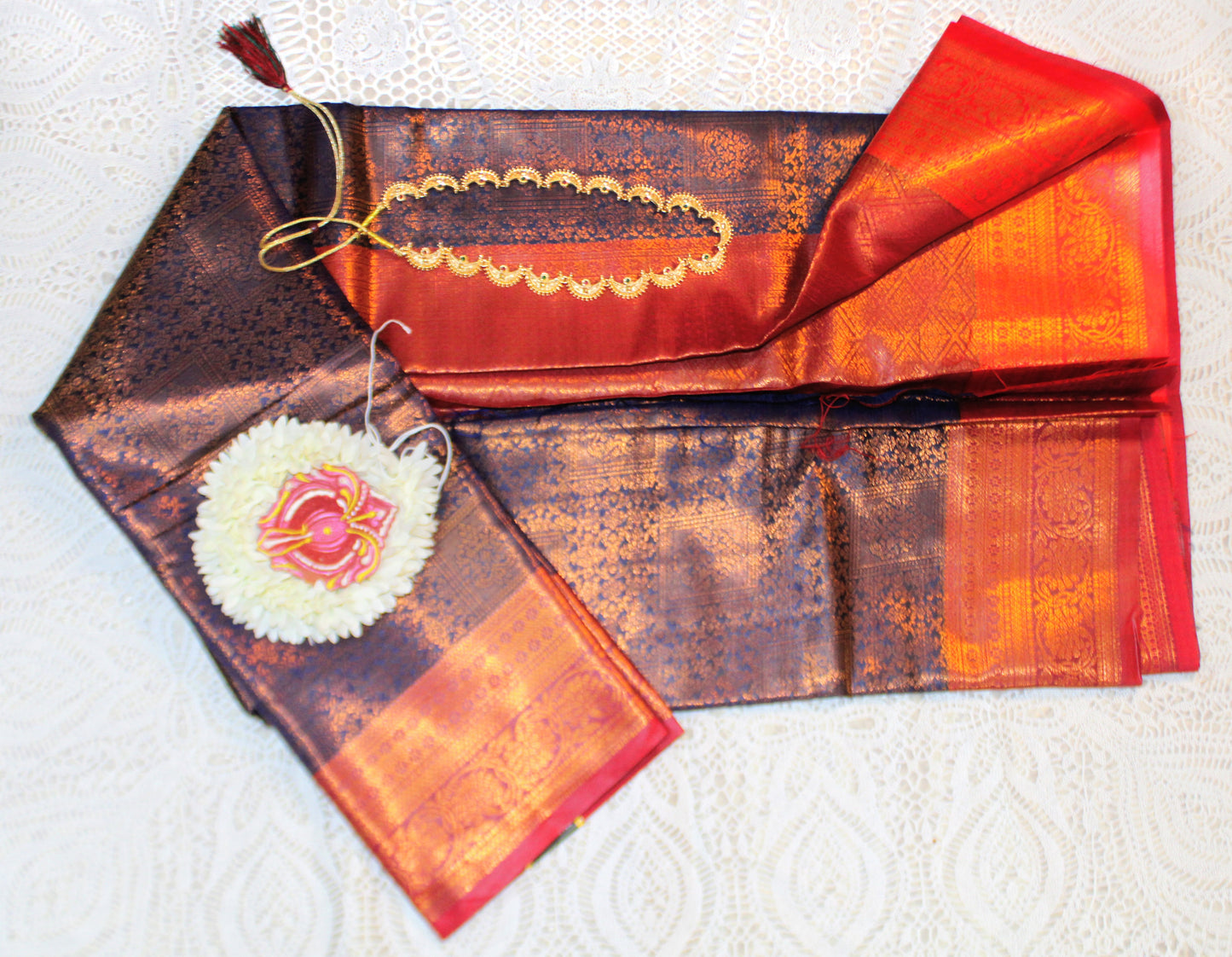 Close-up of golden zari on navy semi silk saree—highlighting dramatic contrast and fine craftsmanship