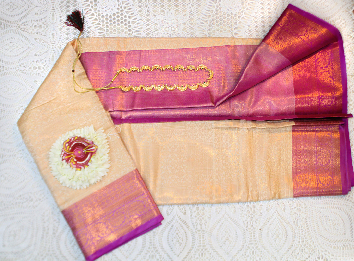 Close-up of golden zari on beige semi silk saree—highlighting subtle shimmer and refined texture