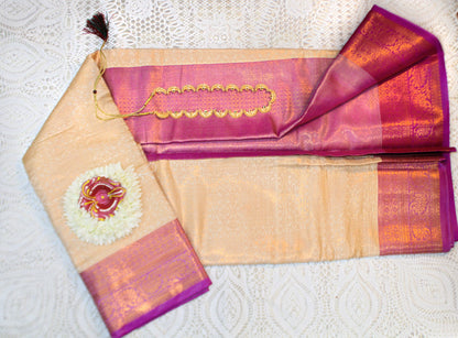 Close-up of golden zari on beige semi silk saree—highlighting subtle shimmer and refined texture