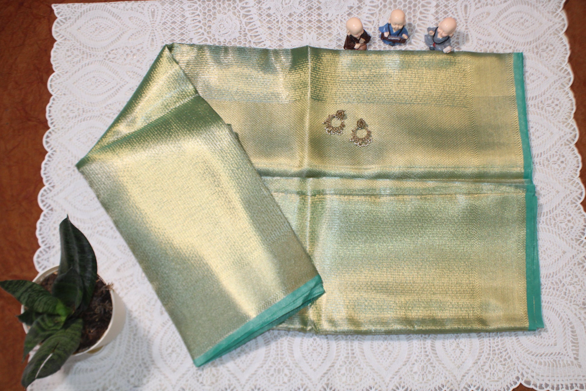 Green saree with flowing pallu and sleek finish—evoking Jyothika’s cultural grace and festive poise.