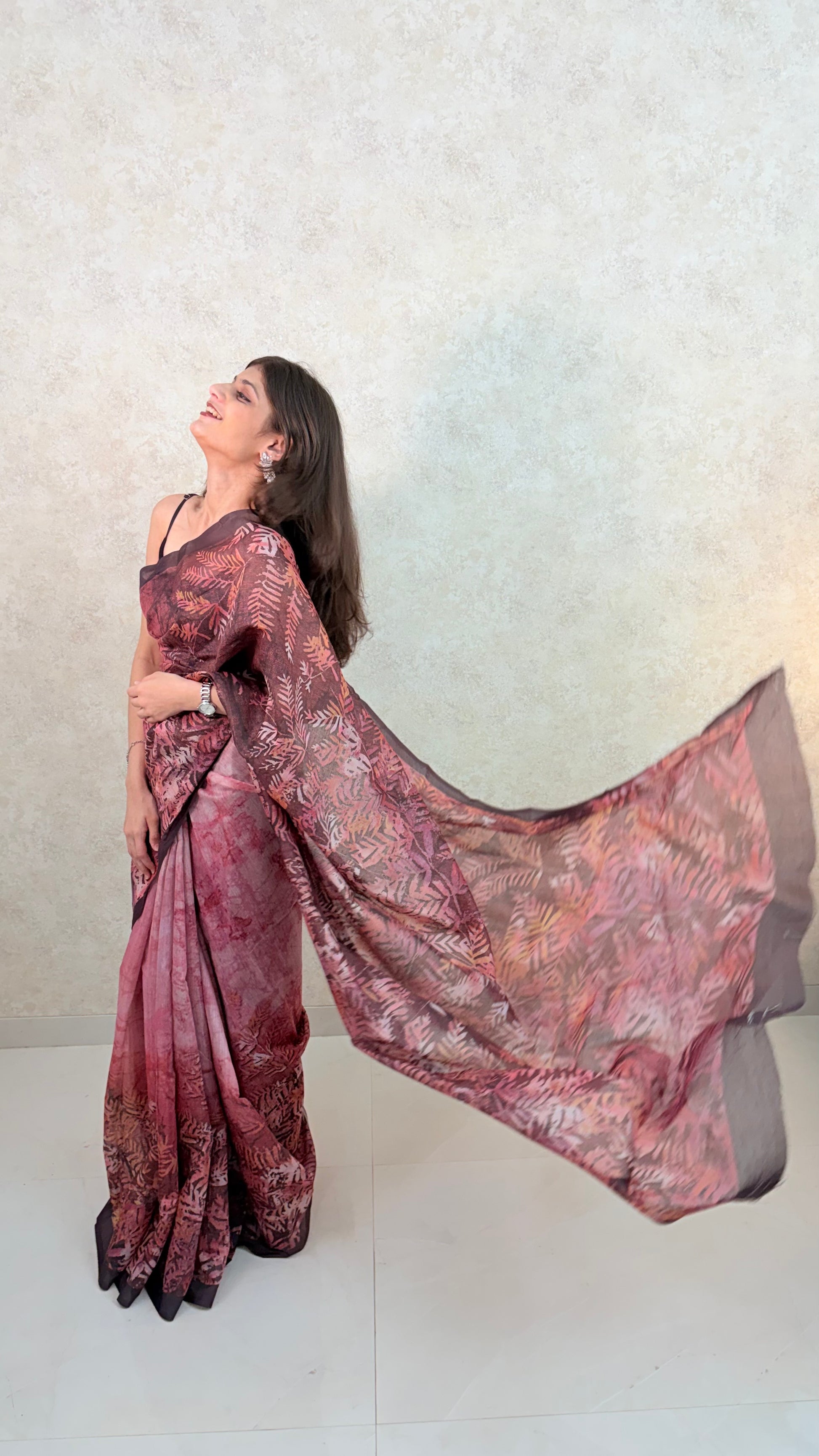 Female model showcasing Art Silk Saree with soft sheen and artistic leaf patterns
