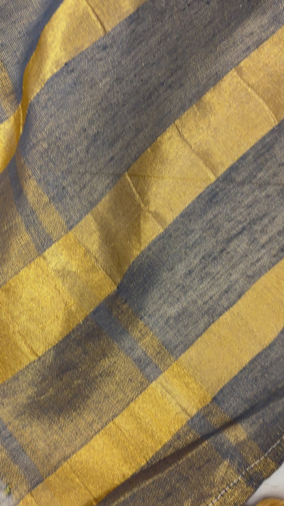 Woman wearing Khadi Tissue Saree in golden tones, exuding festive elegance and grace