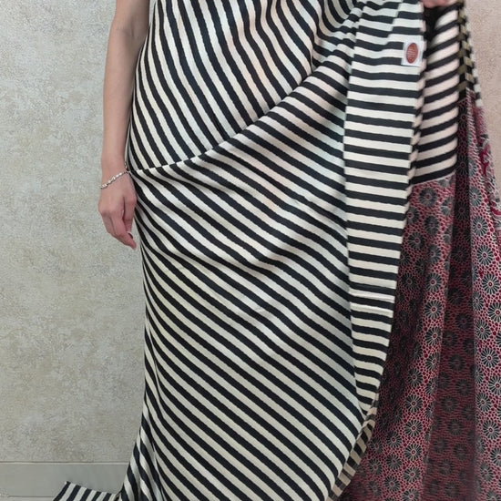 Graceful pose in Modal Silk Saree with linear patterns and a touch of cultural charm