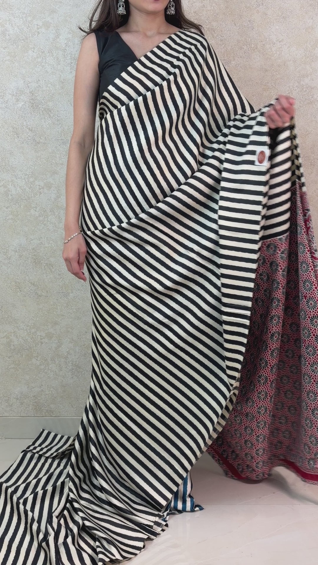 Graceful pose in Modal Silk Saree with linear patterns and a touch of cultural charm