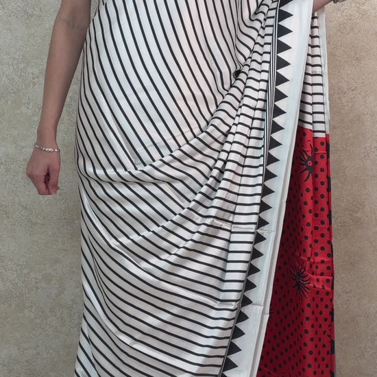 Graceful pose in Black Modal Silk Saree with cool-toned vertical design, exuding effortless sophistication