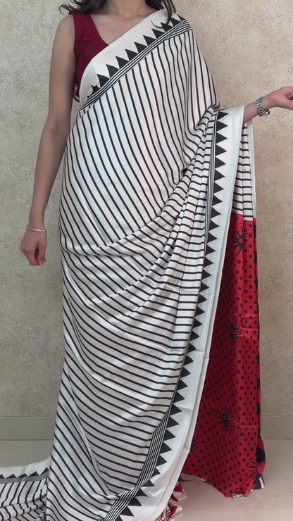 Graceful pose in Black Modal Silk Saree with cool-toned vertical design, exuding effortless sophistication