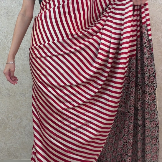 Female model showcasing Modal Silk Saree with artistic stripes and graceful drape