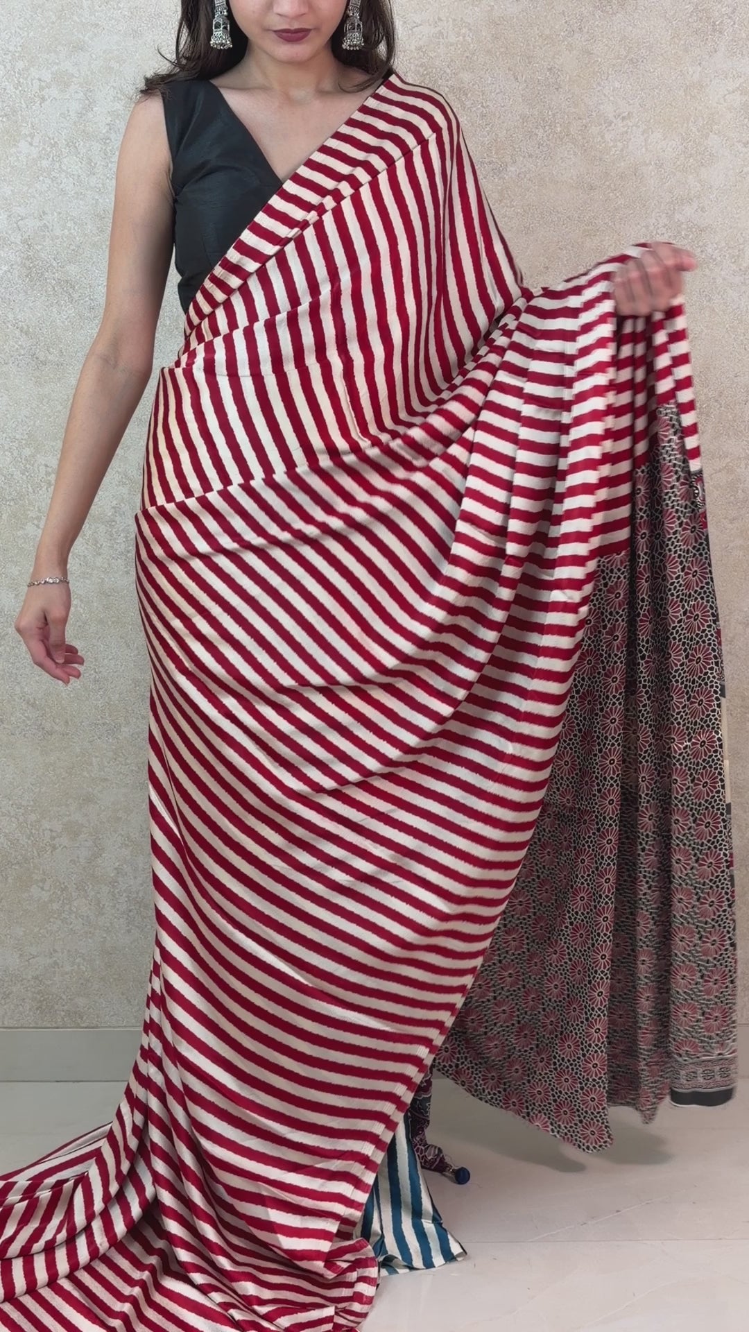 Female model showcasing Modal Silk Saree with artistic stripes and graceful drape